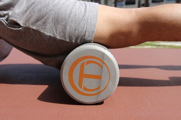 Using a foam roller to massage your muscles is a good active recovery workout idea.